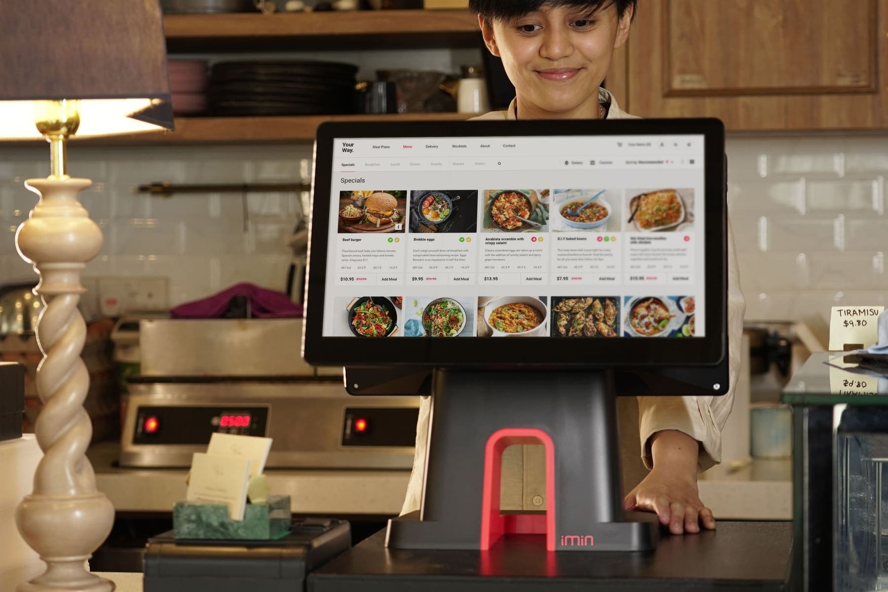 Self-order touchscreen kiosk at a canteen counter