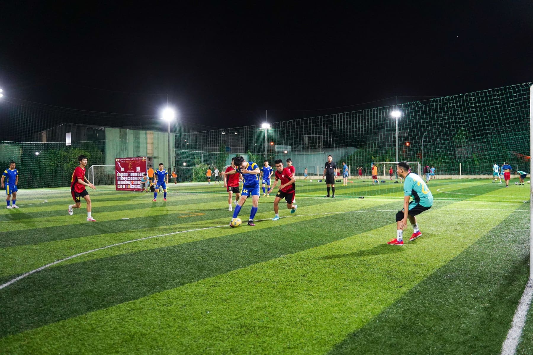 Football on a floodlit artificial pitch at night