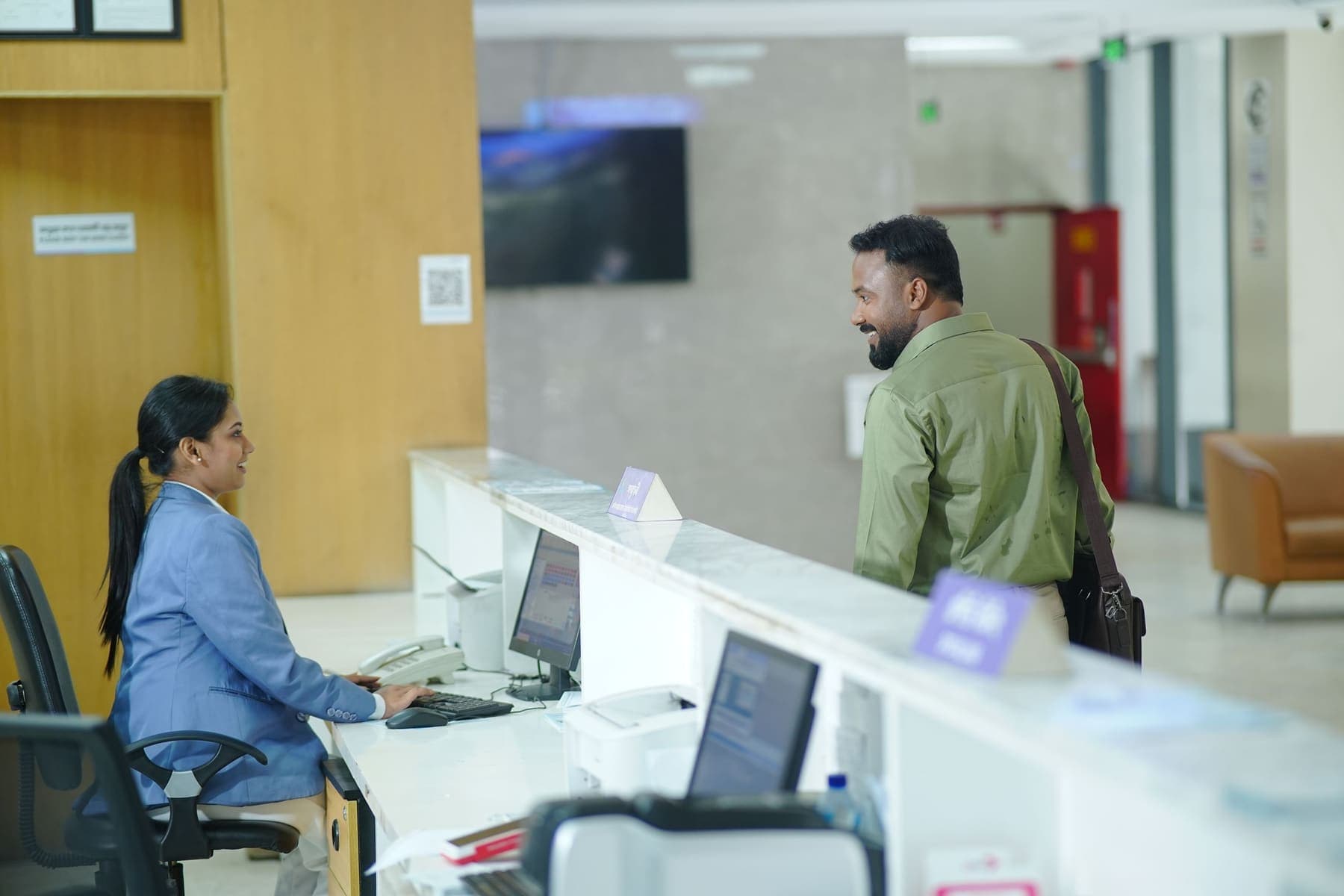 Venue front desk staff greeting a customer