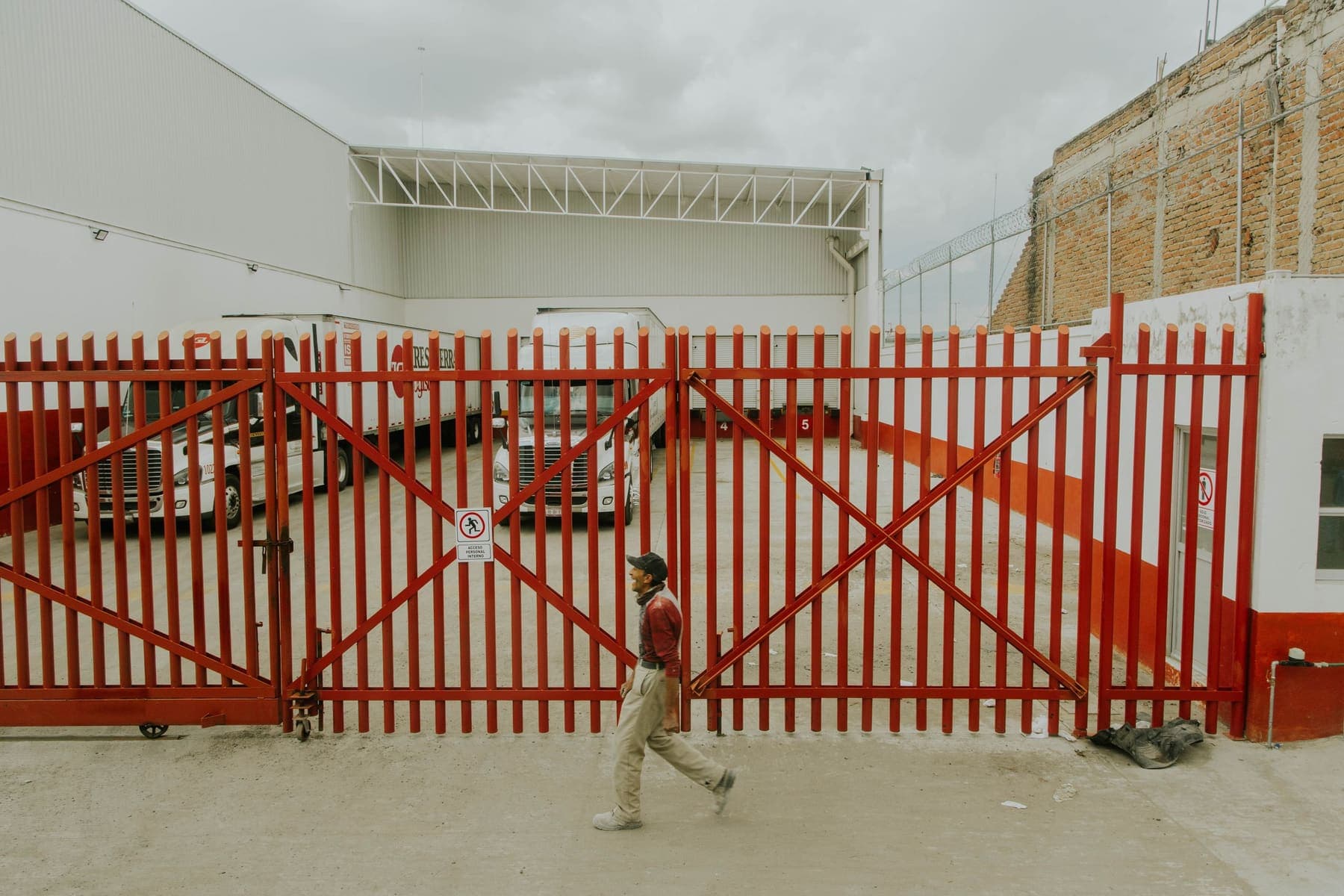 Industrial entrance gate with trucks inside