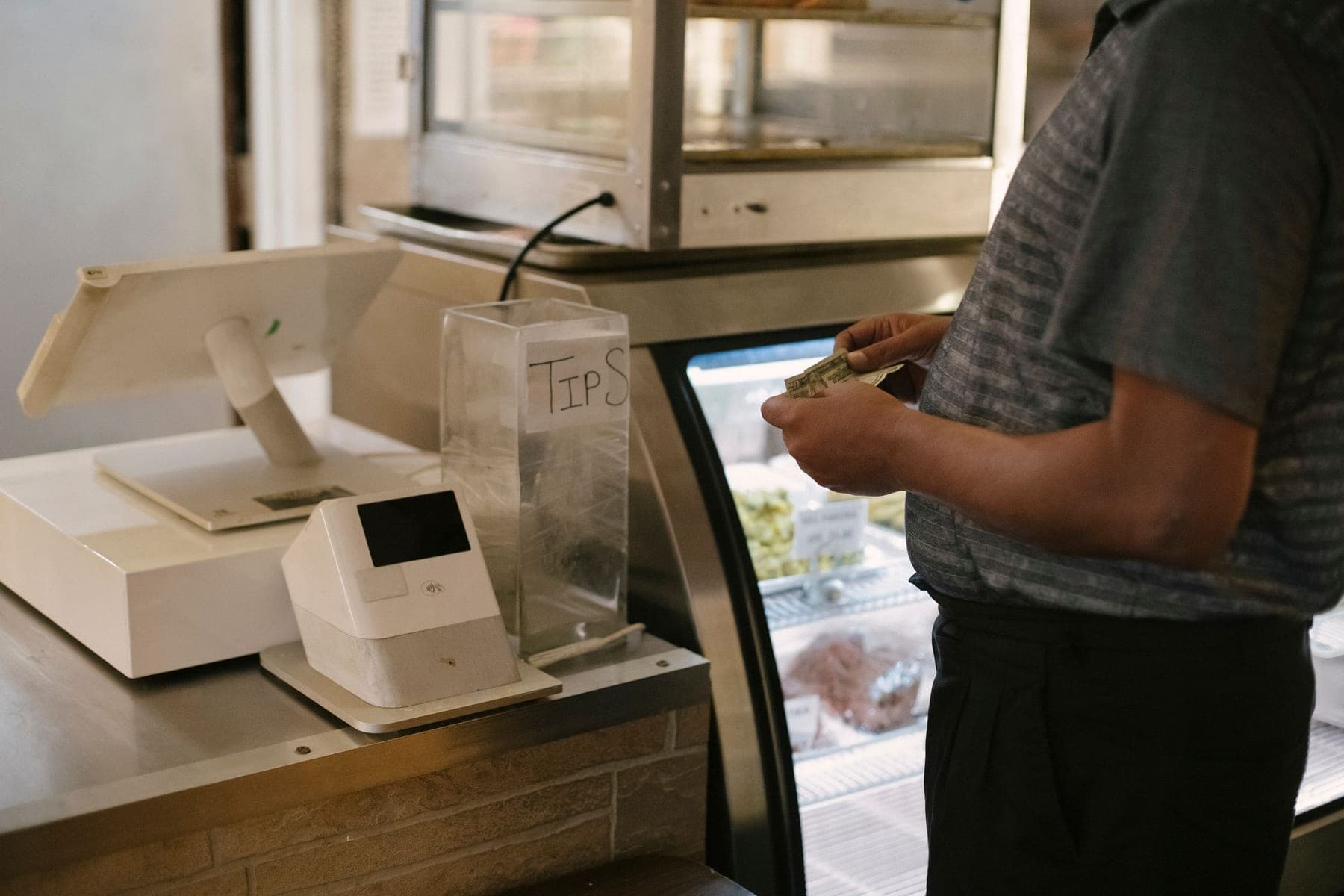 Staff counting cash at the shop counter