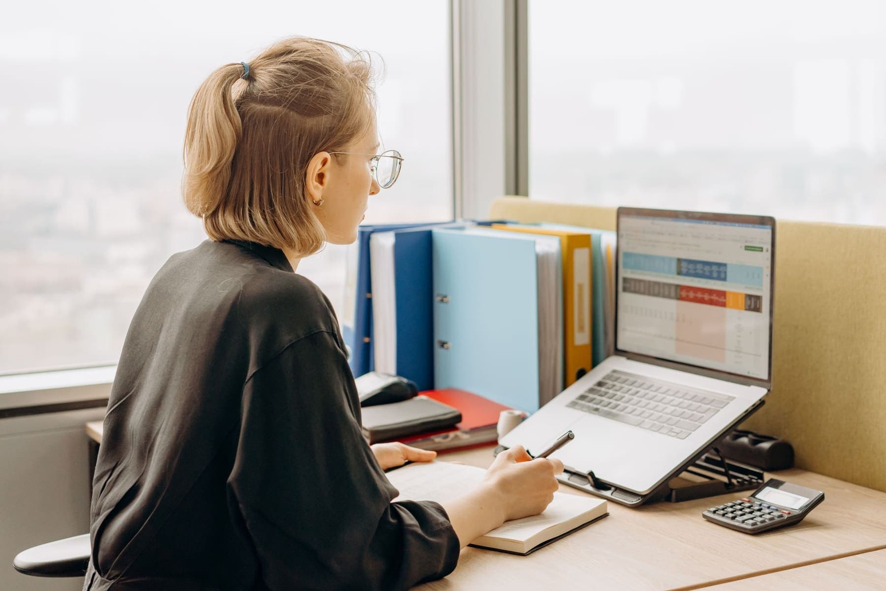 HR staff working on a spreadsheet on a laptop