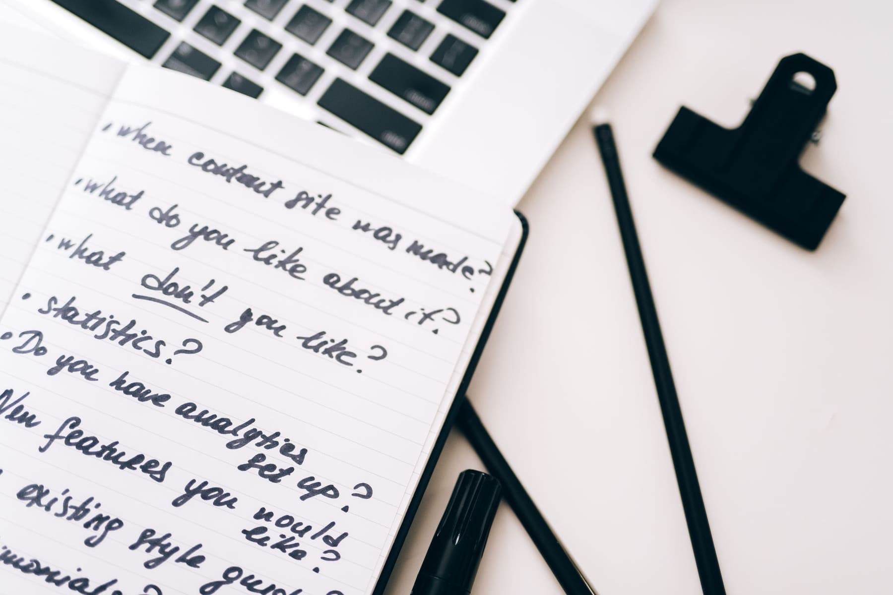 Handwritten notebook on a laptop keyboard