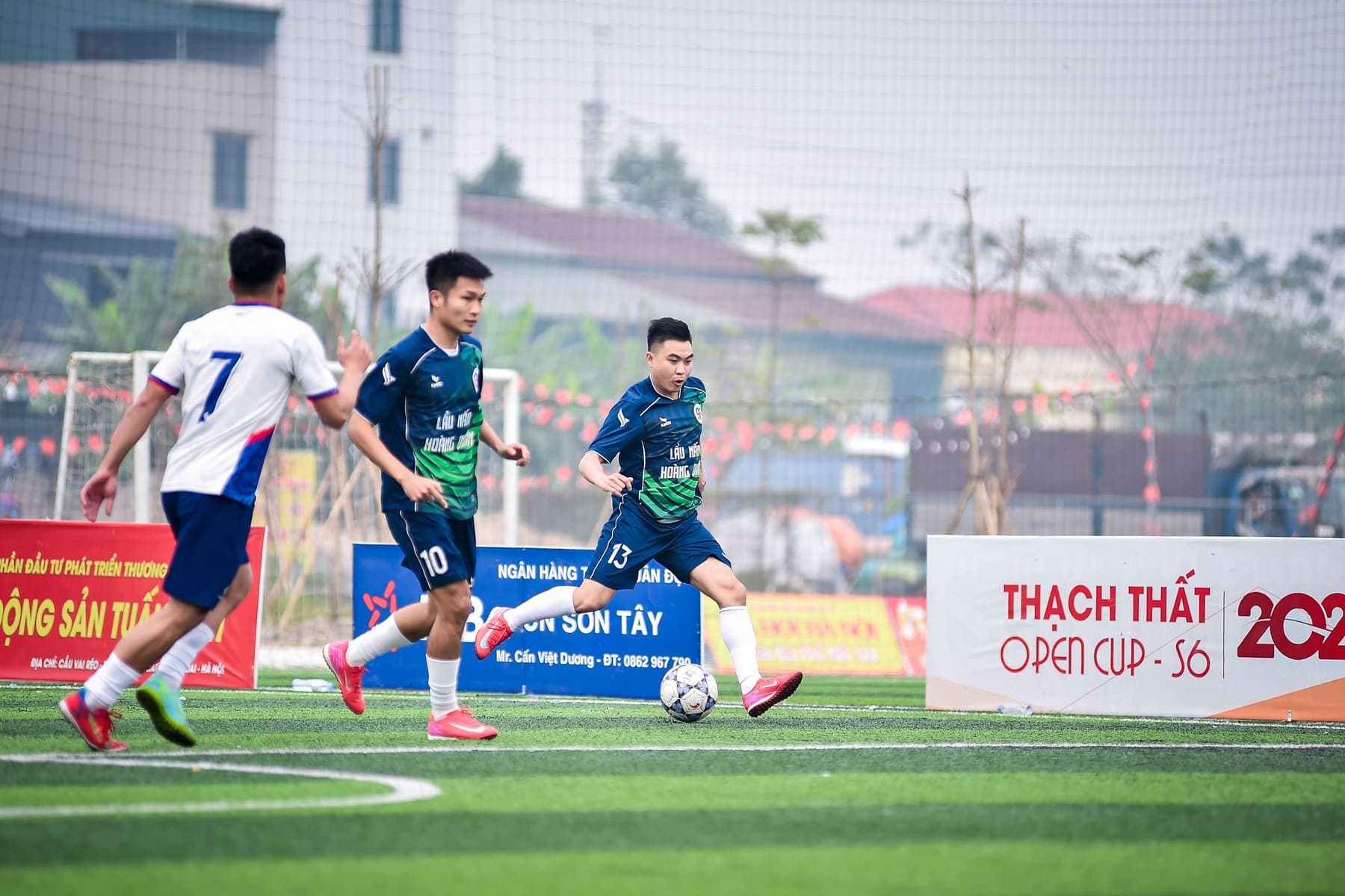 Sponsor boards along the pitch at an amateur tournament