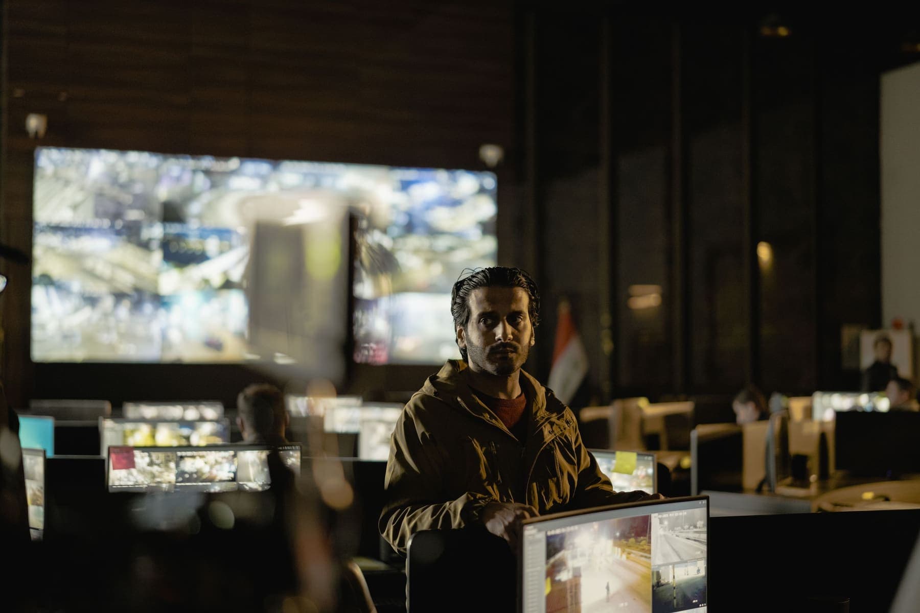 Operator watching CCTV screens in a control room