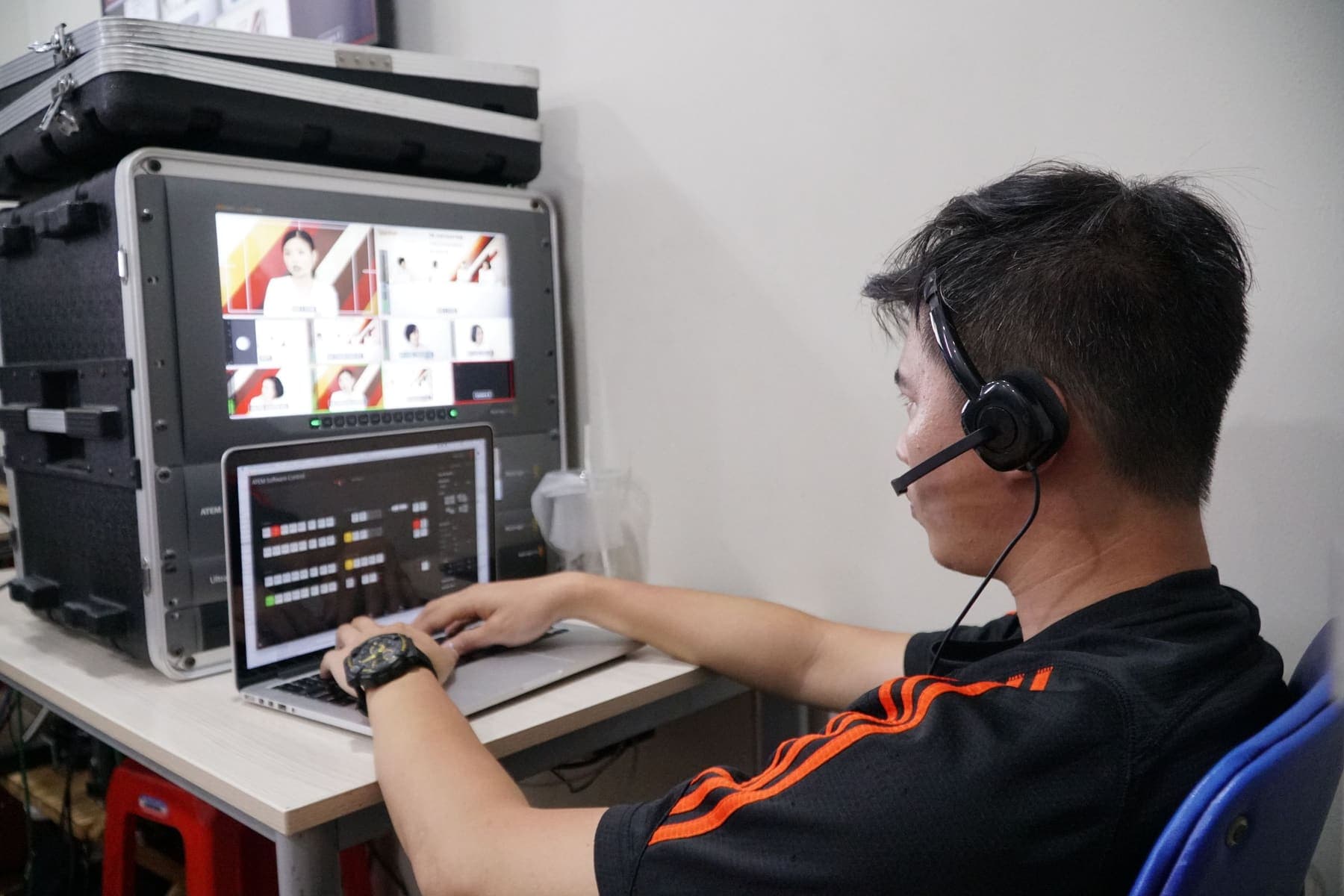 Technician at a multi-screen video switcher